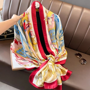 Elegant silk shawl with equestrian and baroque patterns on a luxury sofa setting