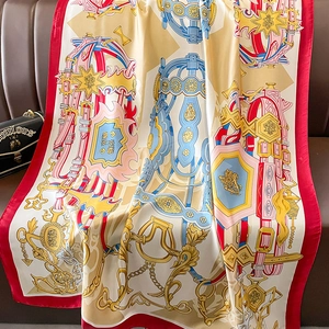 Detail of silk scarf with equestrian print and red border on leather background