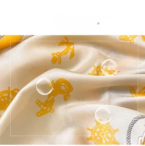 Detailed macro view of nautical print silk scarf featuring anchor and rope patterns
