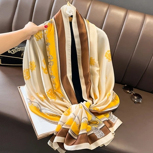 Fashionable nautical print silk scarf featuring steering wheel and chain motifs on beach wrap