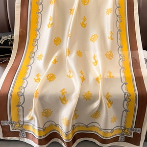 Detailed close-up of a satin scarf featuring a nautical anchor and chain pattern