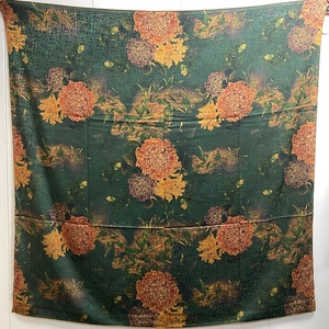 Detailed texture of green floral silk scarf with vintage hydrangea print and satin finish