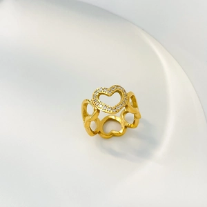 Detailed macro view of gold heart open ring with micro-pave cubic zirconia crystals