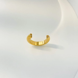 Detail view of gold adjustable ring with two sparkling round zircon stones on ends