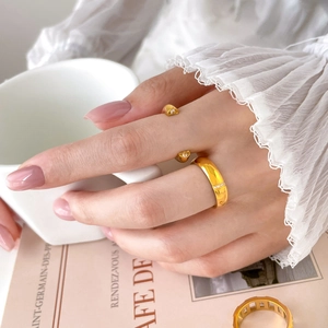 Elegant gold titanium steel ring set with sparkling zircon in a lifestyle setting