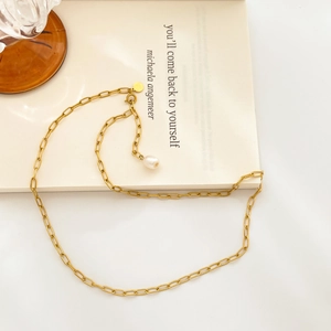 Detail of 18K gold-plated chunky link chain necklace featuring a white pearl pendant
