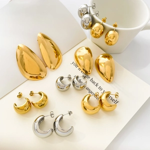 Polished gold and silver dome drop earrings and C-hoops in minimalist geometric designs