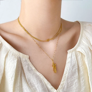 Layered 18K gold-plated snake chain necklace with knot detail and hug pendant