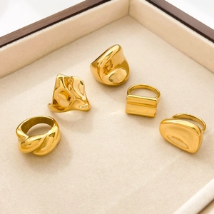 Set of five irregular 18K gold plated stainless steel rings in a beige jewelry box