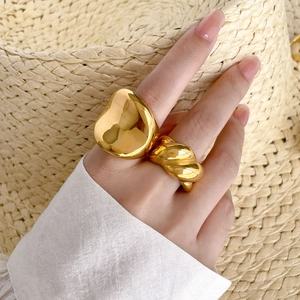 Close-up of chunky 18K gold plated irregular concave ring and twisted rope design