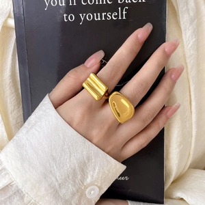 Detailed view of an irregular 18K gold plated ring with textured and smooth finishes