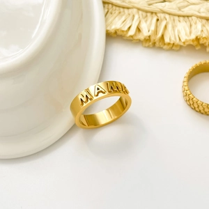 Detailed view of 18K gold plated stainless steel MAMA ring and honeycomb pattern ring