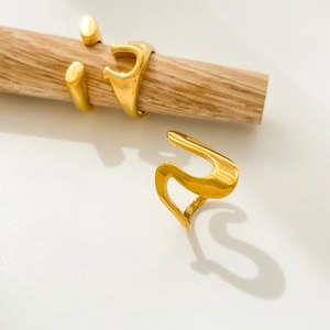 Detail of 18K gold plated titanium steel rings with irregular U-shaped wavy design