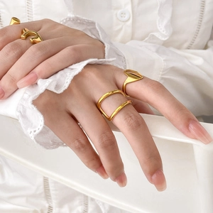 Minimalist gold 18K plated geometric layered rings set worn on female model fingers