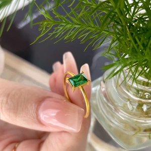 Macro detail of 18K gold-plated titanium ring featuring a square-cut green zircon stone