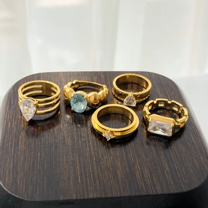Set of gold rings with pear, heart and oval blue cubic zirconia in various band styles