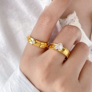 Detail of gold-plated double-layer rings with rhombus and heart-shaped cubic zirconia