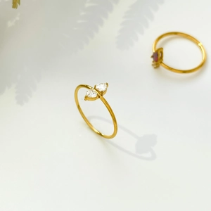 Macro shot of 18K gold plated minimalist rings featuring red and white zircon stones