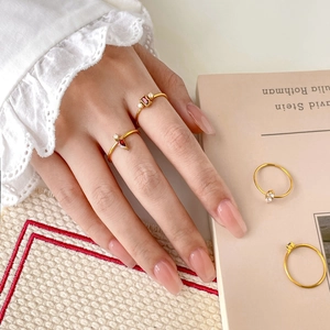 Stackable 18K gold plated rings featuring red pear-cut crystals and fine zircon accents