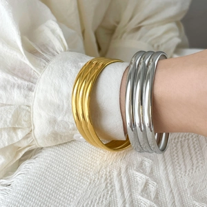 Three-layer curved snake skin design open bangle in gold and silver finish steel