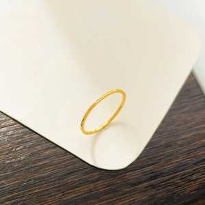 Detail of 18K gold plated titanium steel ring with fine geometric engraved textures