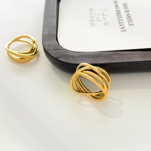 Detail of gold geometric cross rings with multilayered interlaced metal lines