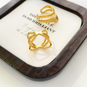 Detailed view of 18K gold plated hollow geometric rings and wavy layering design