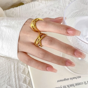 Crossed 18K gold plated geometric ring set worn on model in a minimalist setting