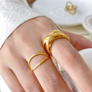 Close-up of geometric 18K gold plated twisted and double-line hollow rings on model