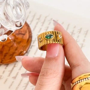 Vintage gold wide band ring with marquise green stone and ribbed texture details