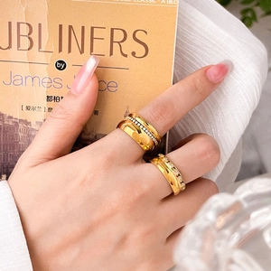 Detail of 18K gold plated titanium rings with pavé zircon settings on a model finger