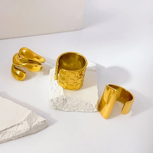 Three-layer 18K gold plated spiral rings and textured wide band on a display stone