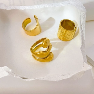 Three-piece gold 18K plated stainless steel ring set featuring irregular textured wide bands