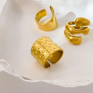 Close-up of 18K gold plated stainless steel rings with smooth and textured finishes