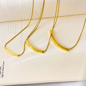 Detail of 18K gold plated snake chain necklaces with sleek rectangular pendants
