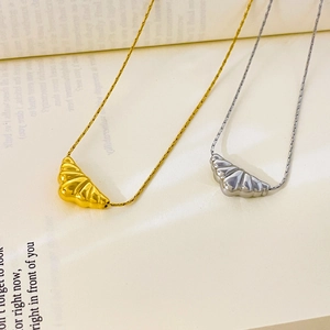 Detailed view of double croissant pendants in gold and silver on an open book