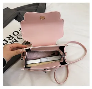 Pink faux leather bag interior showing large capacity with pockets and daily items