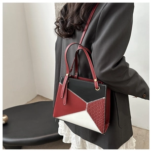 Detail of tricolor geometric patchwork shoulder bag with fine woven side textures