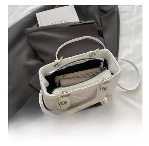 Internal capacity view of quilted crossbody bag with phone and wallet inside