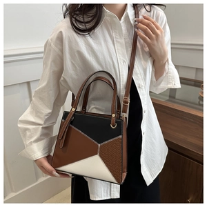 Detail of tricolor geometric tote bag with croc-embossed texture and crossbody strap