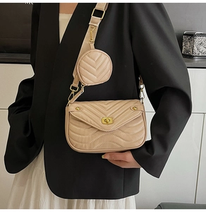 Detail of beige quilted crossbody bag set with wide strap and round coin purse pouch