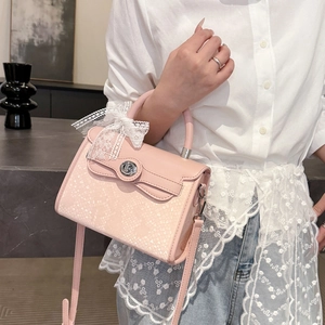 Pink croc-embossed kelly bag with white lace bow and silver twist-lock closure