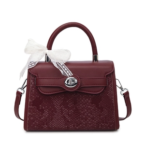 Burgundy Kelly style handbag with snakeskin pattern, silver lock, and lace bow accent