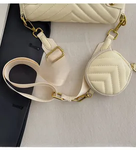 Detail of cream quilted crossbody bag with adjustable wide strap and small round pouch