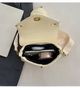 Interior view of cream PU leather crossbody bag showing space for phone and makeup