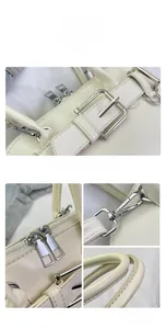 Detail view of smooth off-white leather handbag with silver hardware and stitching