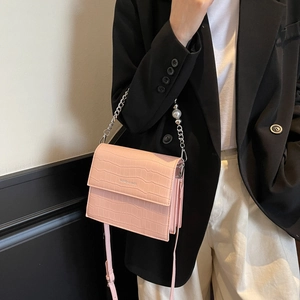 Pink croc-embossed crossbody bag with pearl chain strap and leather handle for women