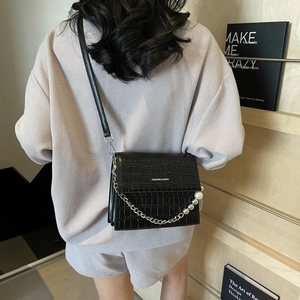 Elegant black crocodile texture crossbody bag with pearl chain handle and silver accents