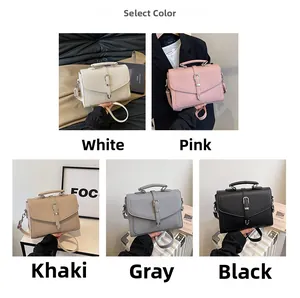 Detail shot of textured soft leather shoulder bags in five colors with metal buckle accents