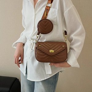Brown V-quilted leather crossbody bag with wide strap and round coin purse pouch